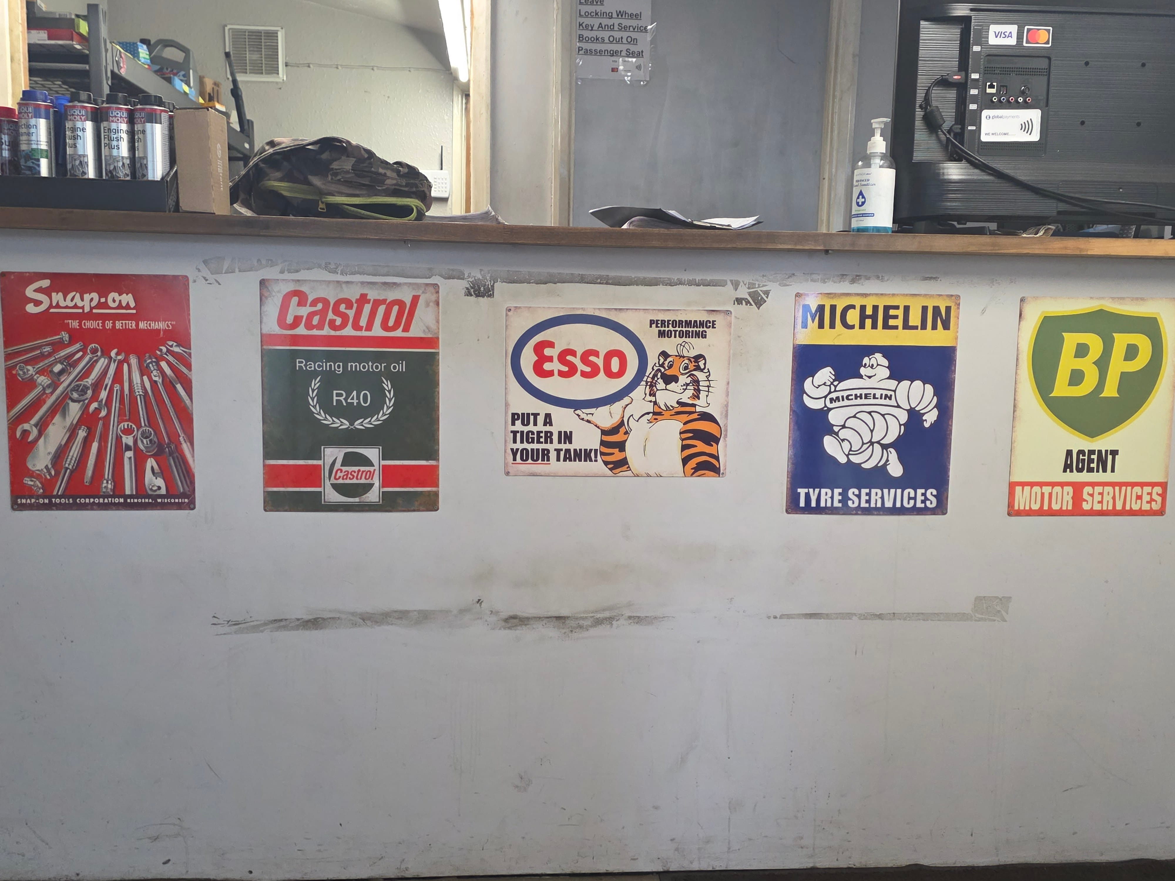 Wall of certificates and classic motorsport memorabilia at Langdon Motors