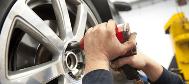 An expert technician performing scheduled maintenance and fresh oil replacement on a modern vehicle engine